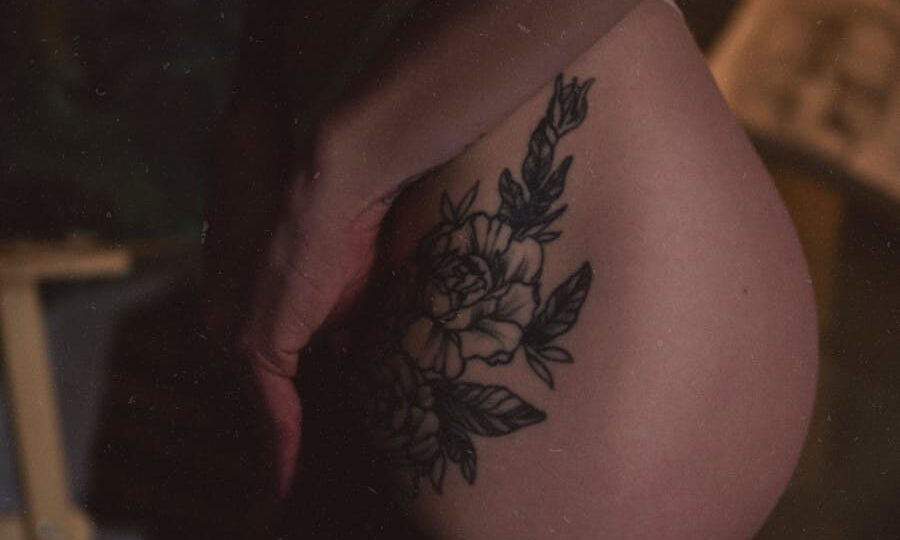 Closeup of Female Body with Rose Tattoo